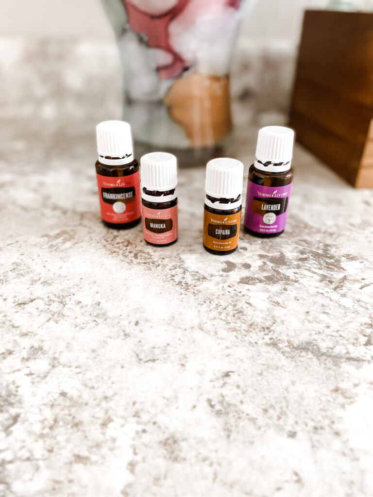Essential oils on a gray bathroom counter.