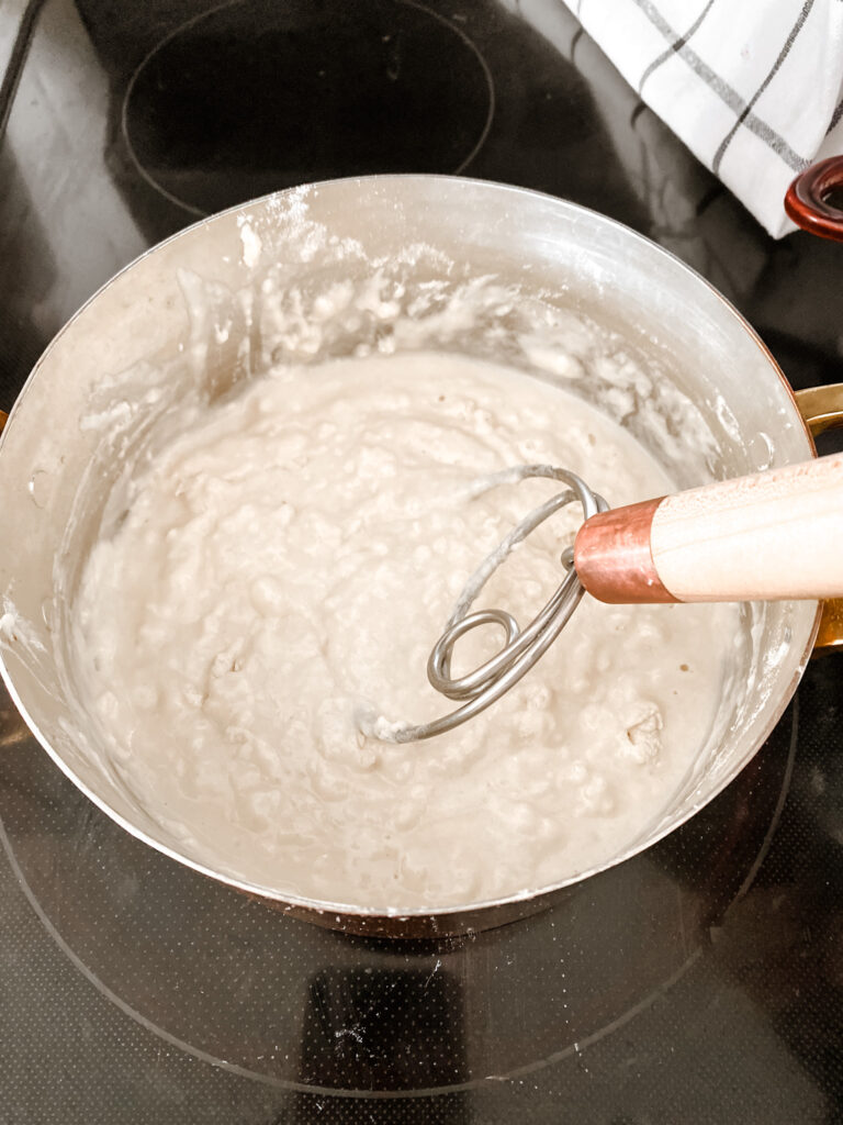 flour, salt, oil, water, being mixed in a pot on the stove